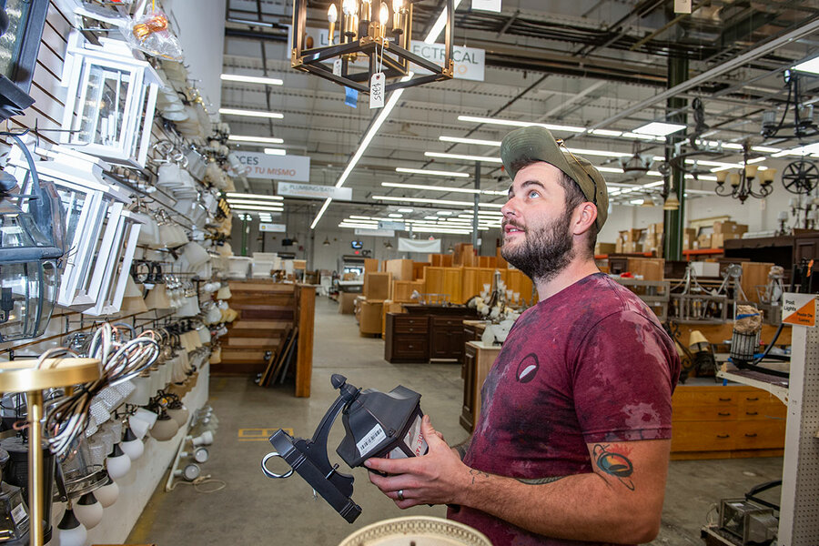 A white man shops for lights at EcoBuilding Bargains