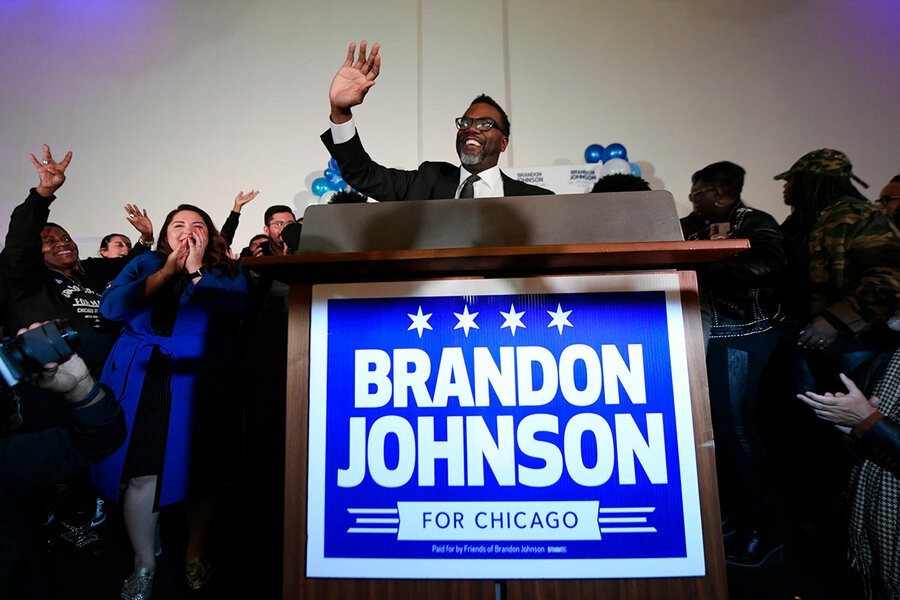 Chicago Mayor Brandon Johnson poses for a photo with members of