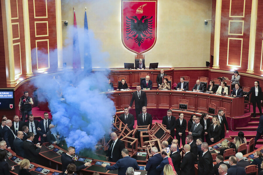 Albanian Parliament votes amid flares, fires, and stacks of chairs