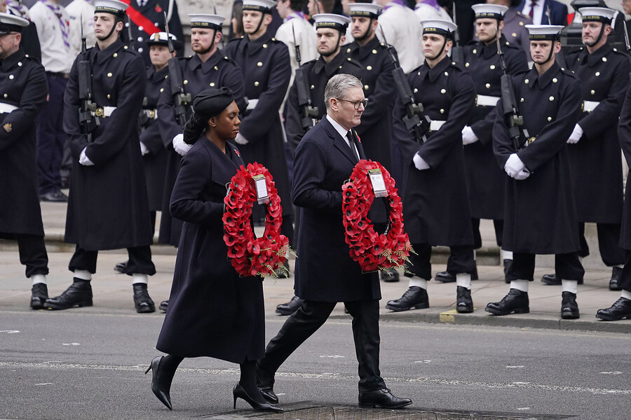 Britain's Prime Minister Keir Starmer, center, and Conservative Party leader Kemi Badenoch carry wreaths as they take part in the Remembrance Sunday service at the Cenotaph in London, Nov. 10, 2024. 