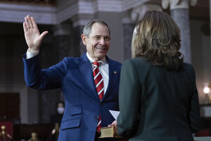 John Curtis raises his right hand, to be sworn in as a U.S. senator.