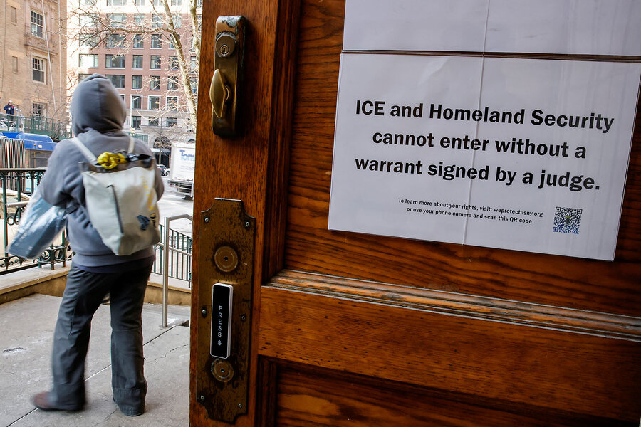 A woman exits St. Paul and St. Andrew United Methodist Church in New York past a sign on a door that says ICE cannot enter without a signed warrant.