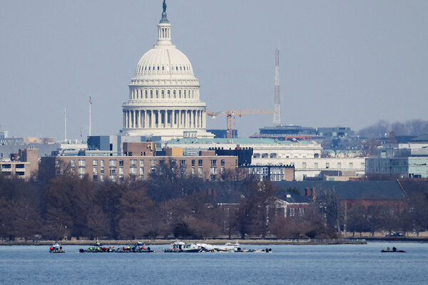 Search and rescue teams operate on the Potomac River, with the U.S. Capitol building in the background.