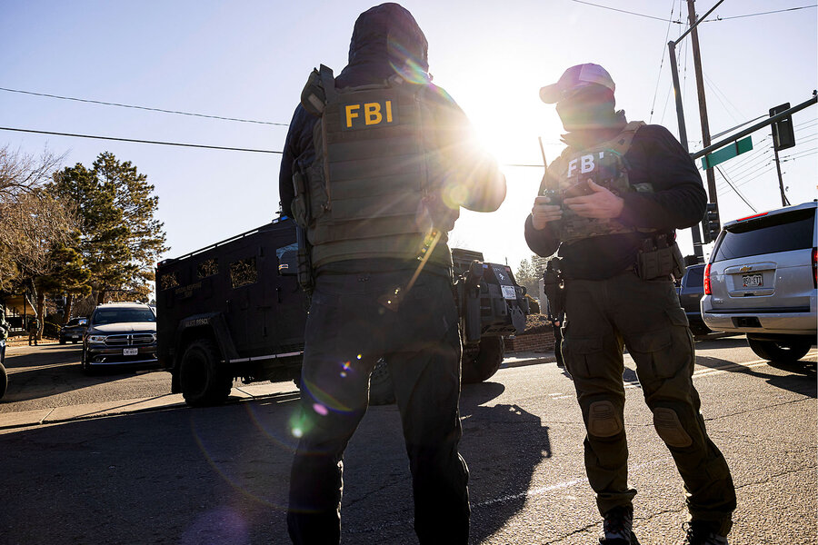 FBI agents interact after conducting a raid in coordination with Immigration and Customs Enforcement at the Cedar Run apartment complex in Denver, Colorado, February 5, 2025.