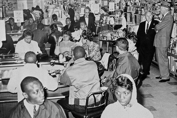 Black protesters in 1960 sit for the second day at a "white only" lunch counter at an Atlanta Woolworth Co.