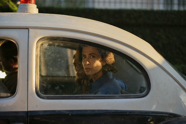 Best actress contender Fernanda Torres looks out a window in the backseat of a car