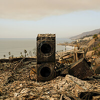 A stacked washing machine and dryer, charred by fire, stands amid rubble of a burned home in the Pacific Palisades neighborhood of Los Angeles, Jan. 11, 2025.