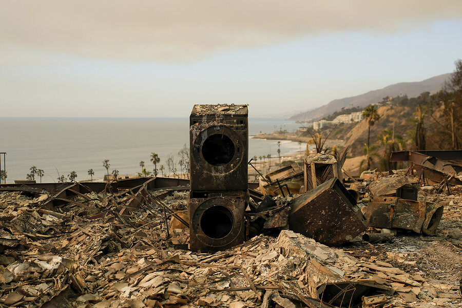 A stacked washing machine and dryer, charred by fire, stands amid rubble of a burned home in the Pacific Palisades neighborhood of Los Angeles, Jan. 11, 2025.