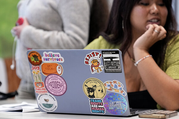 Amanda Garcia looks away from a laptop that is open in front of her