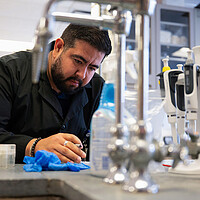 Christian Carrera, a visiting research specialist, processes a specimen as he works on a study under a federal grant from an agency that is part of the National Institutes of Health, at the University of Illinois College of Nursing in Chicago, Feb. 28, 2025. The Trump administration has frozen almost all funding and grant approvals by NIH.