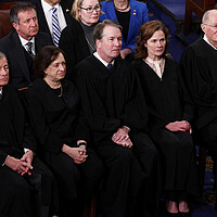 Five U.S. Supreme Court justices stand in a line President Donald Trump's joint address to Congress in Washington on March 4, 2025