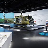 A person walks through a gallery featuring a helicopter at the new National Medal of Honor Museum