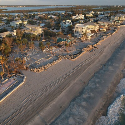 Waves roll in from the Gulf of Mexico toward lots where only empty foundations and debris remain after homes were swept away in Hurricane Milton on Manasota Key in Englewood, Florida, Oct. 13, 2024. 