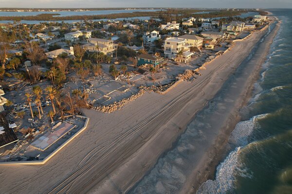 Waves roll in from the Gulf of Mexico toward lots where only empty foundations and debris remain after homes were swept away in Hurricane Milton on Manasota Key in Englewood, Florida, Oct. 13, 2024. 