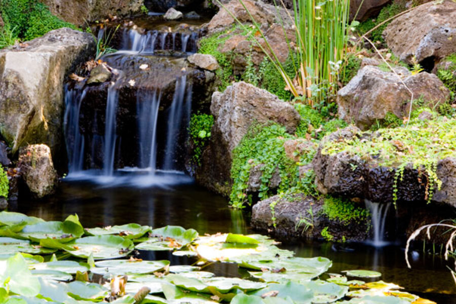 Small waterfall with water splashing and tumbling over the rocks