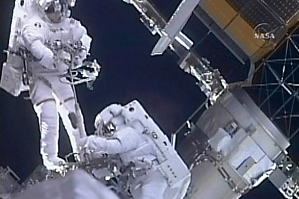 Spacewalk 2 Two astronauts ifloatingi outside ispacei station 